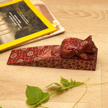 Load image into Gallery viewer, Handmade Batik Cat-Shaped Pule Wood Door Stop in Warm Hues - Feline Space | NOVICA
