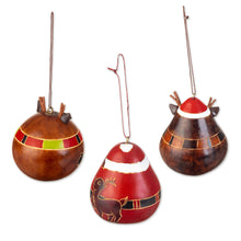 Load image into Gallery viewer, Peruvian Hand-painted Set of 3 Dried Gourd Holiday Ornaments - Santa and His Reindeer | NOVICA
