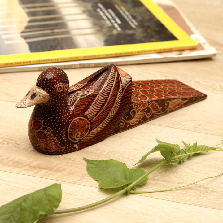 Handmade Batik Duck-Shaped Pule Wood Door Stop in Warm Hues - Duck Dimension | NOVICA