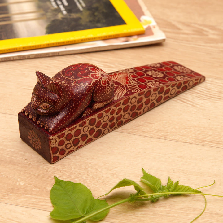 Handmade Batik Cat-Shaped Pule Wood Door Stop in Warm Hues - Feline Space | NOVICA